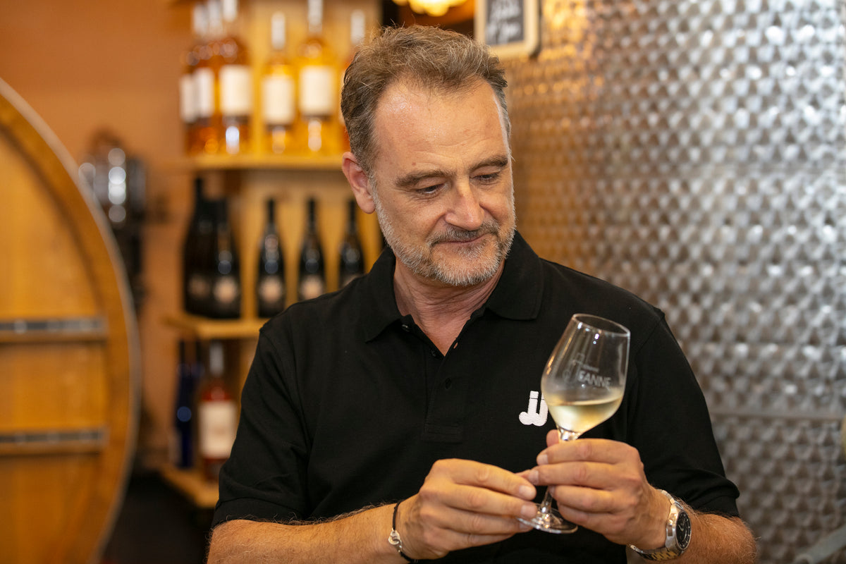 Laurent Berger, sales at Domaine des Jeanne, tasting wine in the cave